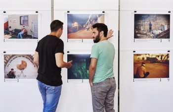 Alon Sahar (L) and Shay Davidovich, both former Israeli army soldiers, discuss in front of photographs at an exhibition of the Israeli NGO "Breaking the Silence" at the Kulturhaus Helferei on June 3, 2015 in Zurich. Israel's Foreign Affairs strongly protested against the financial support provided by Switzerland to the exhibition organized by "Breaking the Silence", a very critical organization about its army.    AFP PHOTO / MICHAEL BUHOLZER -- RESTRICTED TO EDITORIAL USE, MANDATORY MENTION OF THE ARTIST UPON PUBLICATION, TO ILLUSTRATE THE EVENT AS SPECIFIED IN THE CAPTION -- / AFP / MICHAEL BUHOLZER